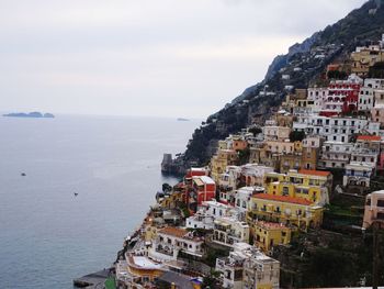 High angle view of townscape by sea against sky