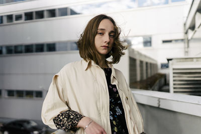 Portrait of beautiful young woman standing outdoors