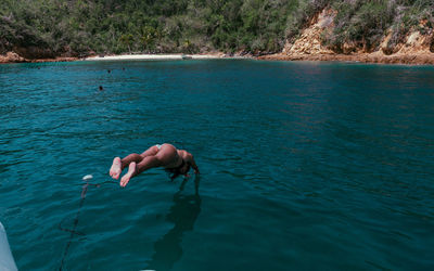 High angle view of young woman diving in sea