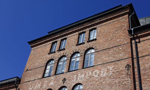 Low angle view of building against clear blue sky