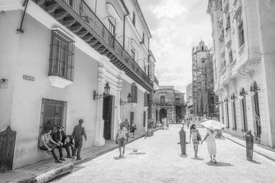 People walking on street amidst buildings