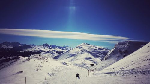 Scenic view of snow covered mountains against sky