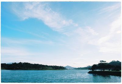 Scenic view of river against cloudy sky