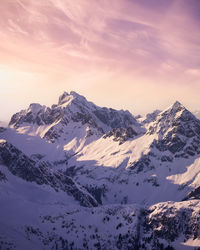 Scenic view of snowcapped mountains against sky during sunset