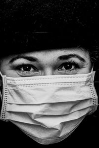 Close-up portrait of woman covering face with hair