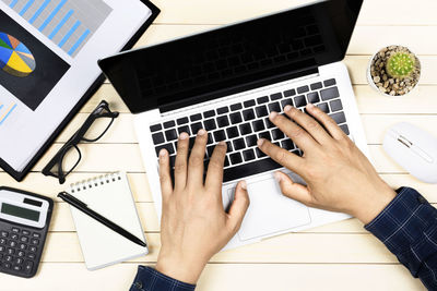 High angle view of person using smart phone on table