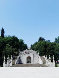 Gazebo in park against clear blue sky