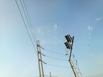 Low angle view of electricity pylon against sky