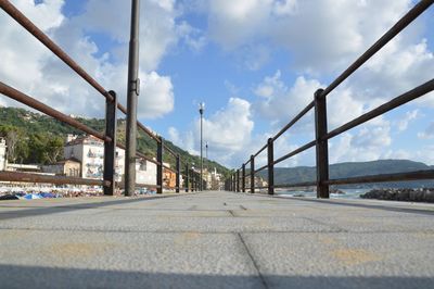 Empty road against cloudy sky