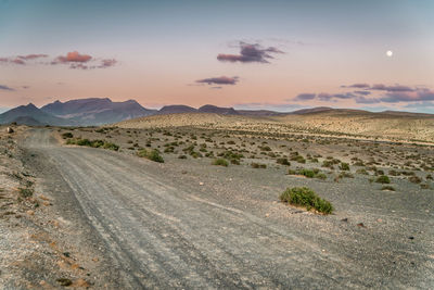 Scenic view of desert against sky during sunset