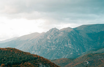 Scenic view of mountains against cloudy sky