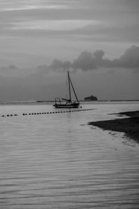 Sailboat in sea against sky