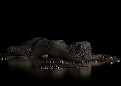 Close-up of illuminated lighting equipment against black background