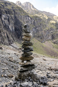 Stack of rocks on land against sky