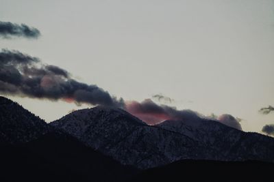 Low angle view of snowcapped mountain against sky