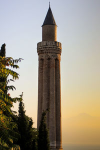 Low angle view of tower against sky during sunset