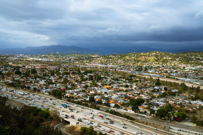 High angle view of road by buildings against sky