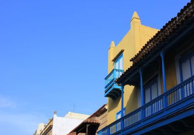 Low angle view of buildings against blue sky