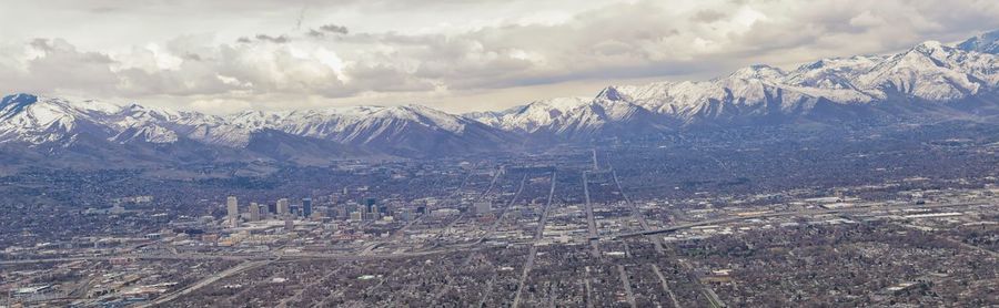 Wasatch front rocky mountain range aerial snow capped peaks winter urban salt lake city utah usa