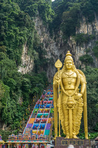 Batu caves in kuala lumpur colorful stairs with golden statue