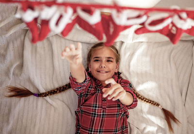 High angle view of cute girl standing against curtain