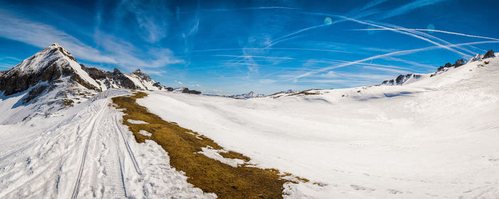 Panoramic view of landscape against blue sky