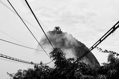 Low angle view of mountain cable car against sky