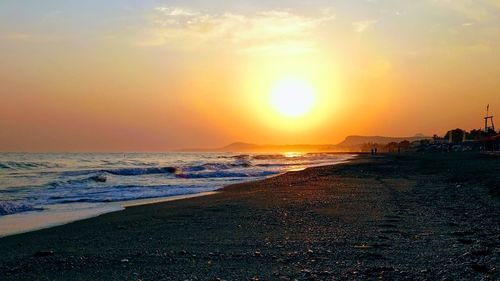 Scenic view of beach against sky during sunset