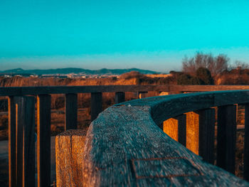 Close-up of railing against clear blue sky