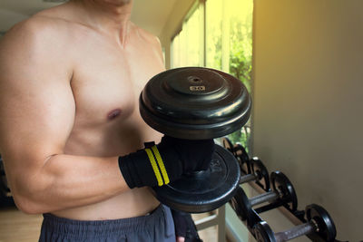 Midsection of shirtless man