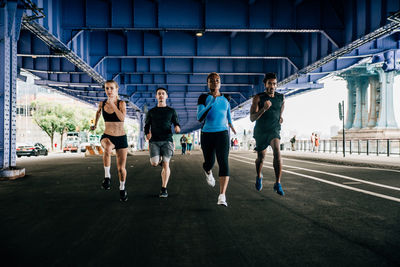 People running on road in city