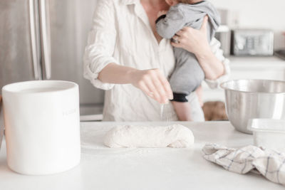 Midsection of woman preparing food at home