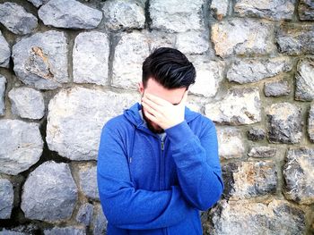 Portrait of a young man standing outdoors