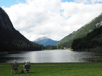 Scenic view of lake against cloudy sky