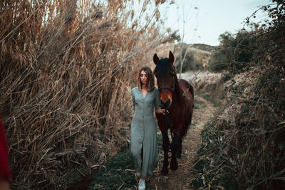 Full length of women walking with horse