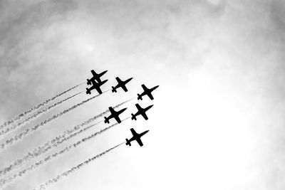 Low angle view of airplane flying against sky