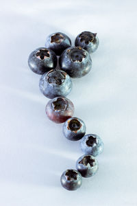 Close-up of blueberries against white background