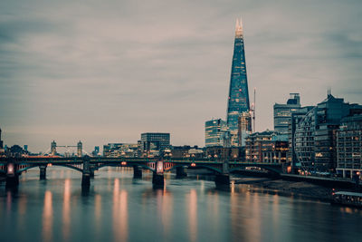 Bridge over river with buildings in background