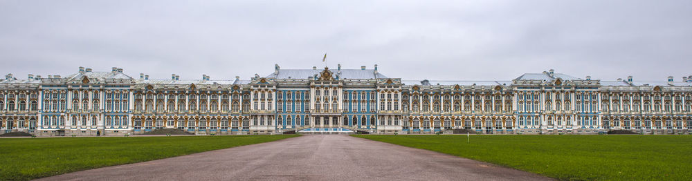 View of palace in city against cloudy sky