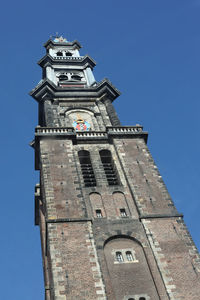 Low angle view of clock tower against blue sky