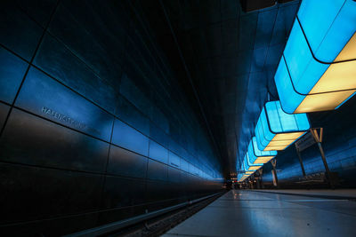 Illuminated railroad station against blue sky