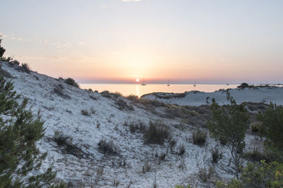 No people sunrise over sailing boats at capo comino sardinia italy