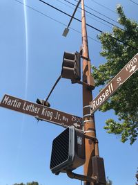 Low angle view of road sign against sky