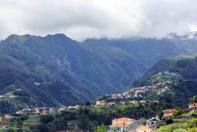 High angle view of townscape and mountains against sky