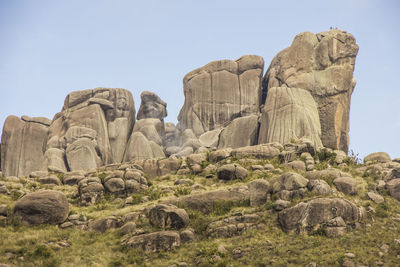 Low angle view of rocks against clear sky