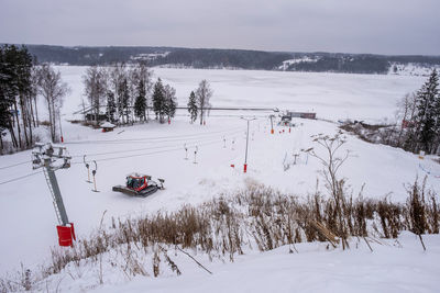 Scenic view of snow covered field against sky