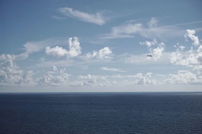 Scenic view of sea against cloudy sky