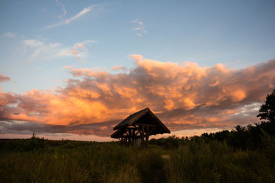 Silhouette built structure against sky at sunset