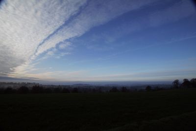 Scenic view of field against sky during sunset