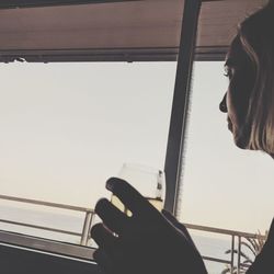 Woman looking through window